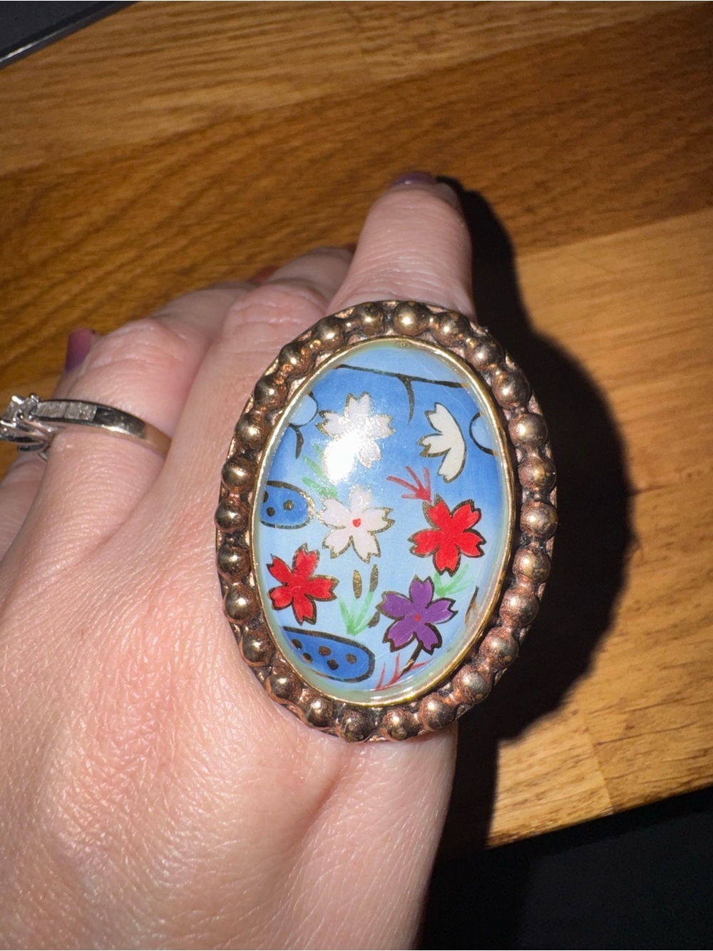 Amy Kahn Russell bronze ring with hand painted oval floral center. Size 8